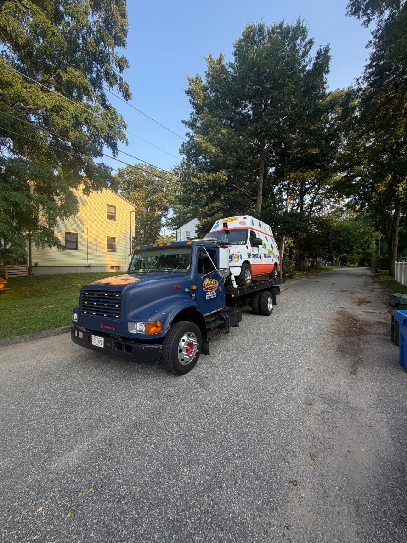Nieves Towing flatbed transporting an ice cream truck